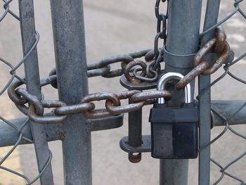 Close-up of padlock on metal gate