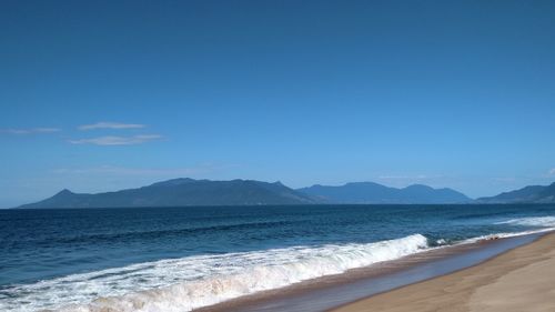 Scenic view of sea against blue sky