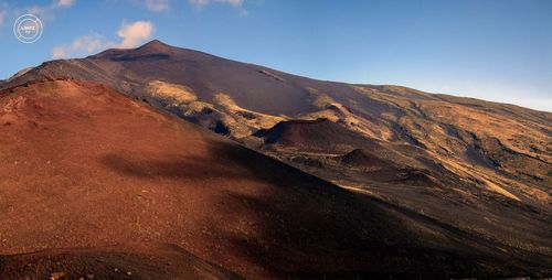 Scenic view of volcanic mountain against sky