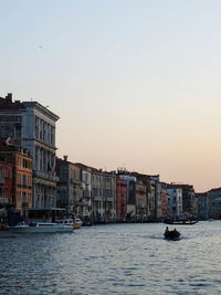 Buildings in city at sunset