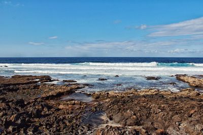 Scenic view of sea against blue sky