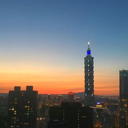 Illuminated city at sunset