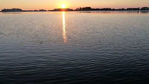 Scenic view of lake against sky during sunset