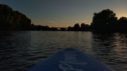 Scenic view of lake against clear sky at sunset