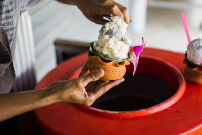 Midsection of person holding ice cream