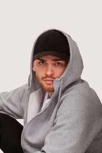 Portrait of young man against white background