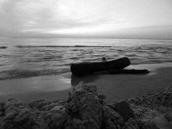 Scenic view of rocks on beach against sky