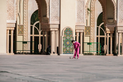 Woman walking in front of building