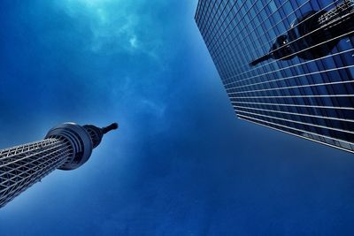 Low angle view of modern building against blue sky