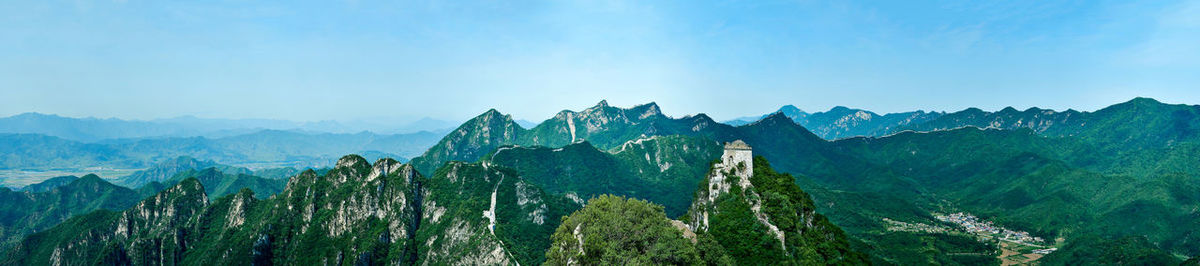 Panoramic view of mountain range against blue sky