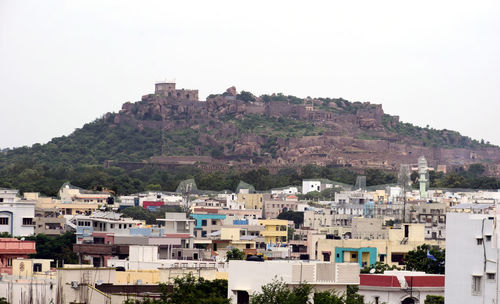 Buildings in city against clear sky