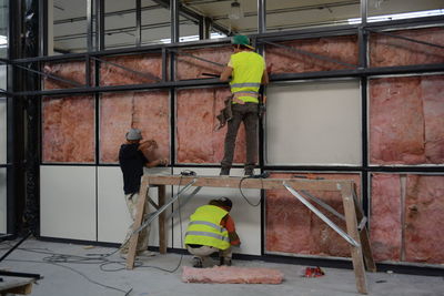 Rear view of workers at construction site