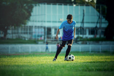 Full length of man playing soccer on field