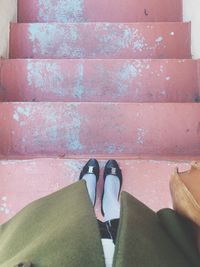 Low section of woman standing on tiled floor