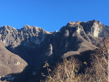 Scenic view of mountains against clear blue sky