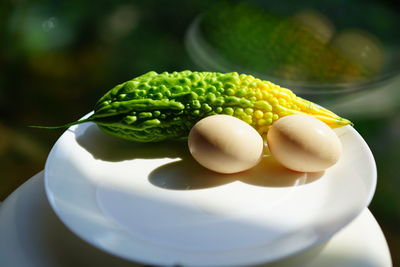 Close-up of green eggs in plate on table