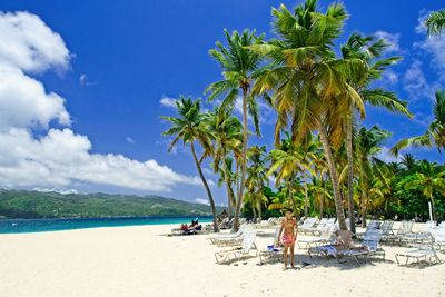 Palm trees on beach against sky