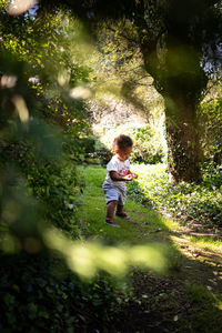 Toddler explores city park in summer