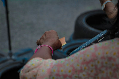 Close-up high angle view of woman holding tobacco product