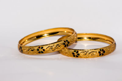 Close-up of wedding rings against white background