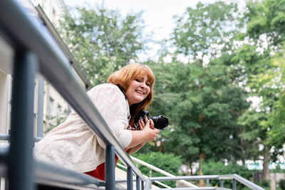 Travel, tourism and entertainment. plus size woman photographer working at the street