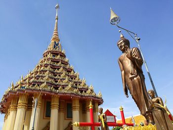 Low angle view of statue against temple