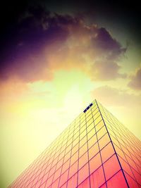 Low angle view of building against cloudy sky