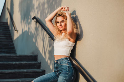 Woman standing by staircase