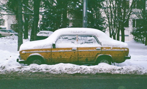 Snow covered car on land