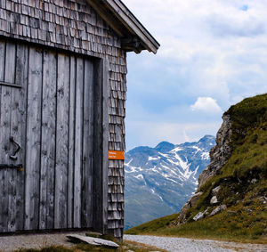 Building by mountains against sky