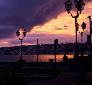 Silhouette of street light against sky during sunset