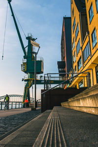 Low angle view of railway bridge in city against sky