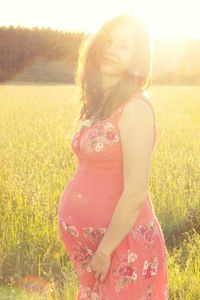 Rear view of woman standing on grassy field