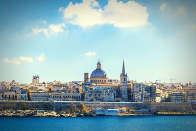 View of cathedral in city against cloudy sky ,