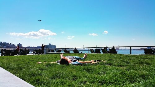 View of tourists enjoying at waterfront park