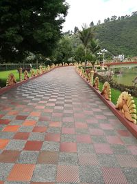 Road amidst trees against sky