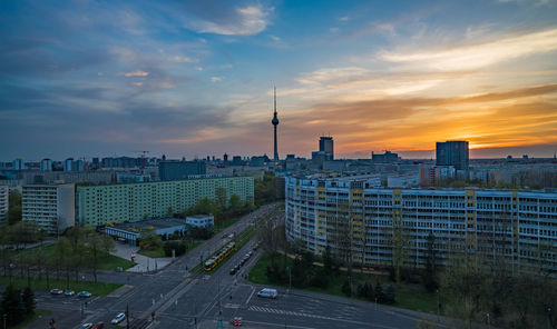 Buildings and television tower - berlin against sky during sunset