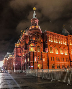 Illuminated building against sky at night