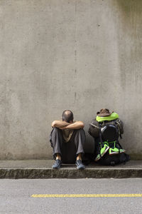 Men sitting on road in city