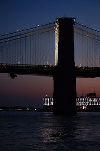Low angle view of suspension bridge at night