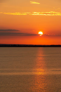 Scenic view of sea against romantic sky at sunset