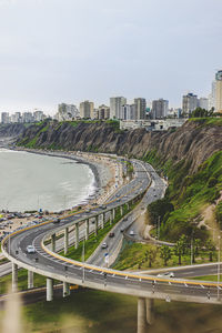 High angle view of road by city against sky