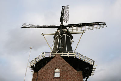 Low angle view of traditional windmill against sky