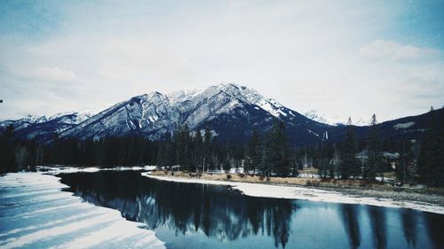 Scenic view of snow covered mountains against sky