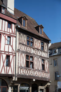 Low angle view of old building against blue sky