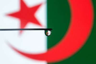 Reflection of algerian flag on water drop