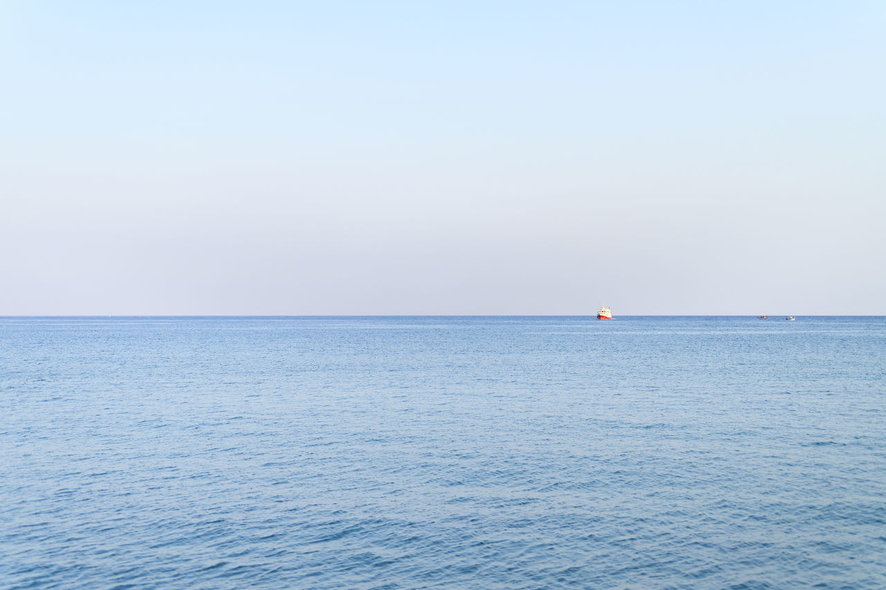 SAILBOATS IN SEA AGAINST CLEAR SKY