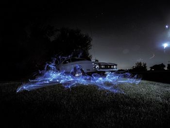 Light painting on sea against sky at night