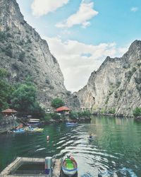 Scenic view of lake by mountains against sky