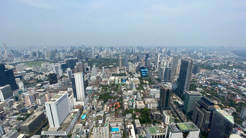 High angle view of modern buildings in city against sky